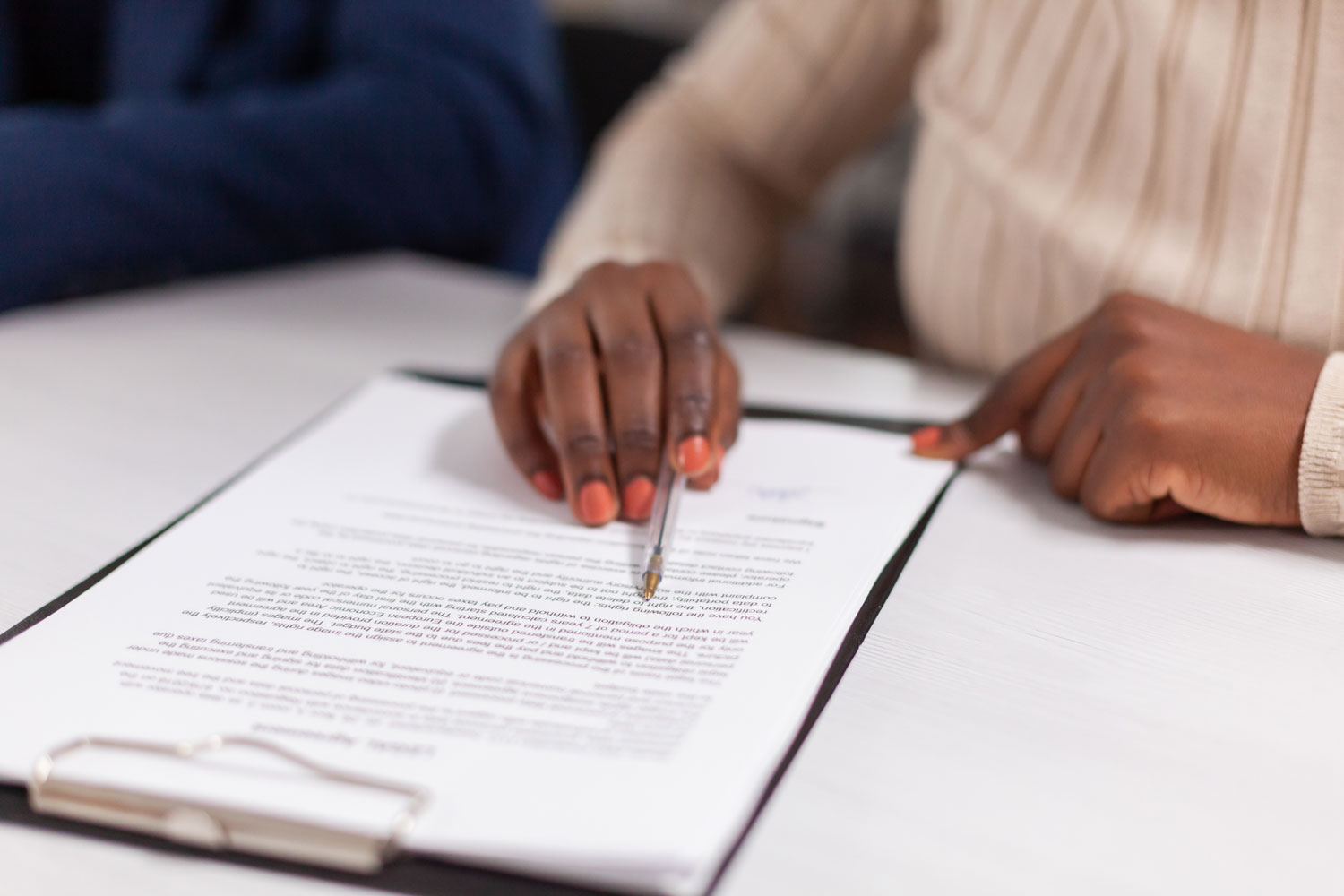 Woman signs paperwork