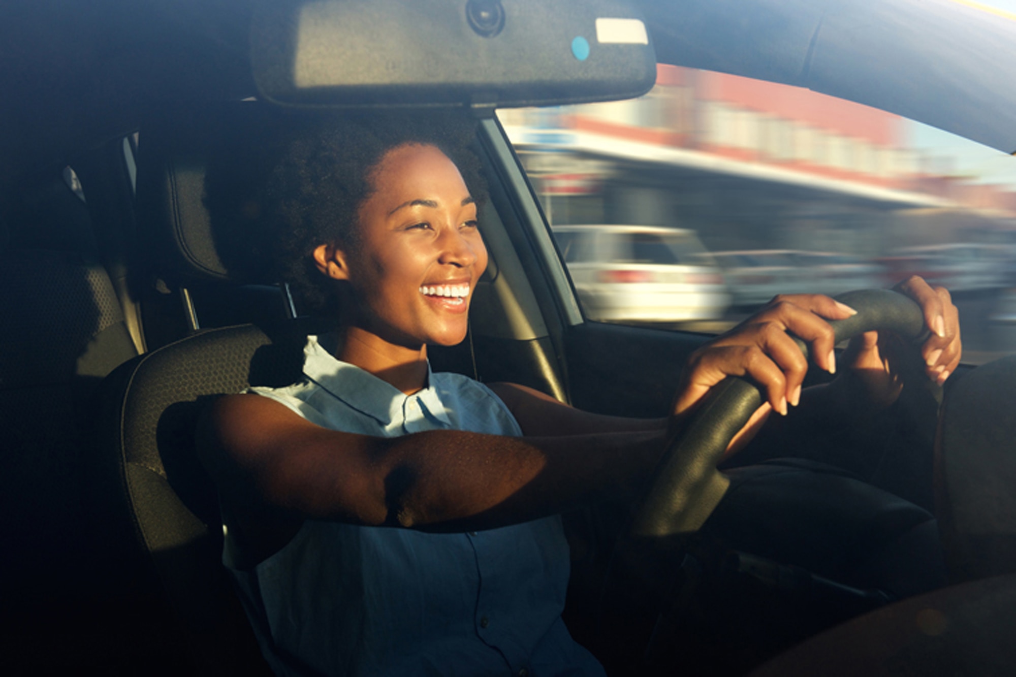 Smiling woman driving a car