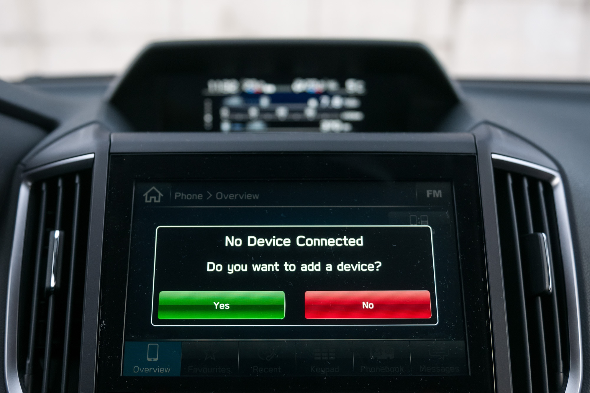 A car infotainment screen prompting to add a device.