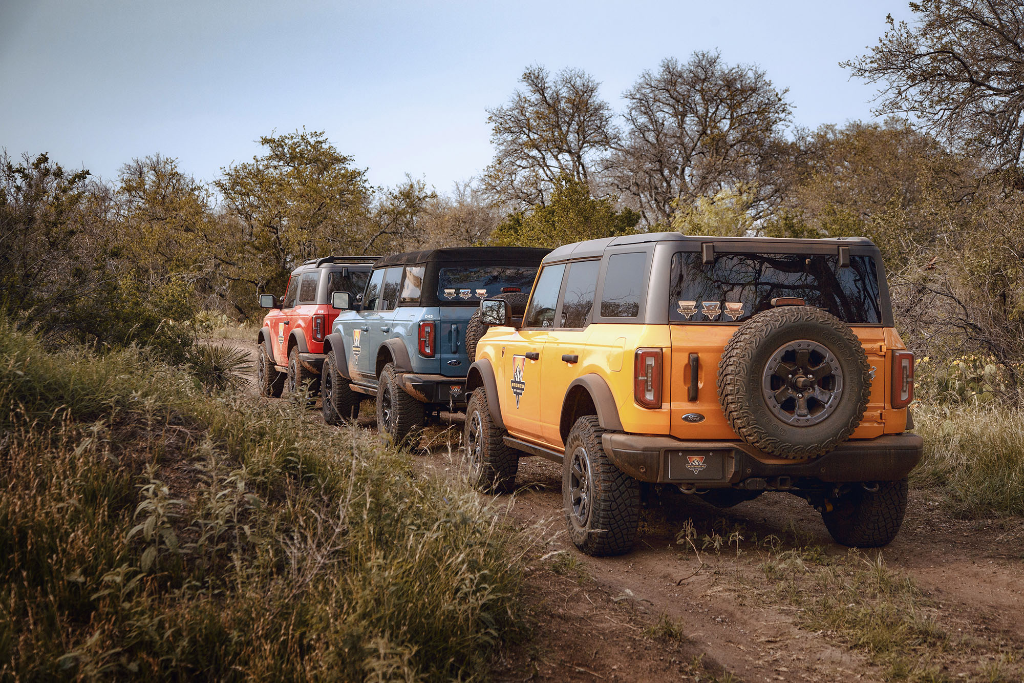 Trio of Ford Broncos on an off-roading trail.