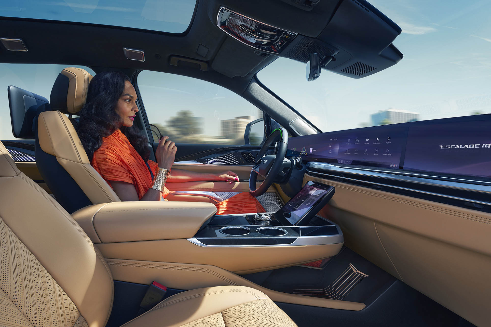 Person sits in driver's seat of Cadillac Escalade IQ with hands off steering wheel