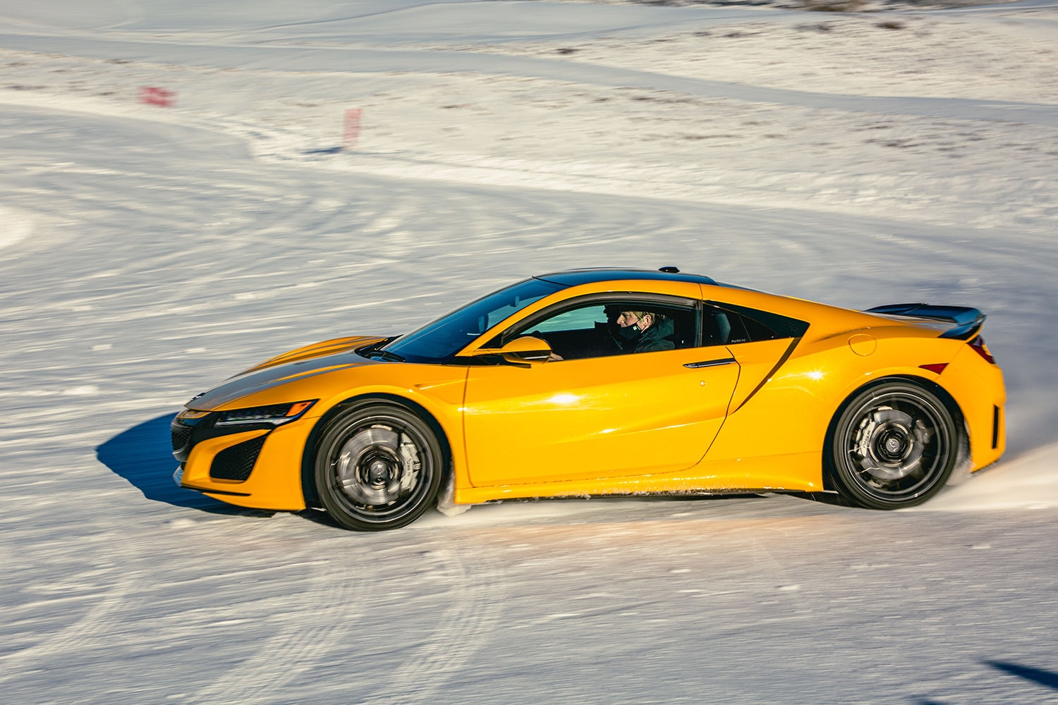 Yellow Acura NSX Sliding in Snow