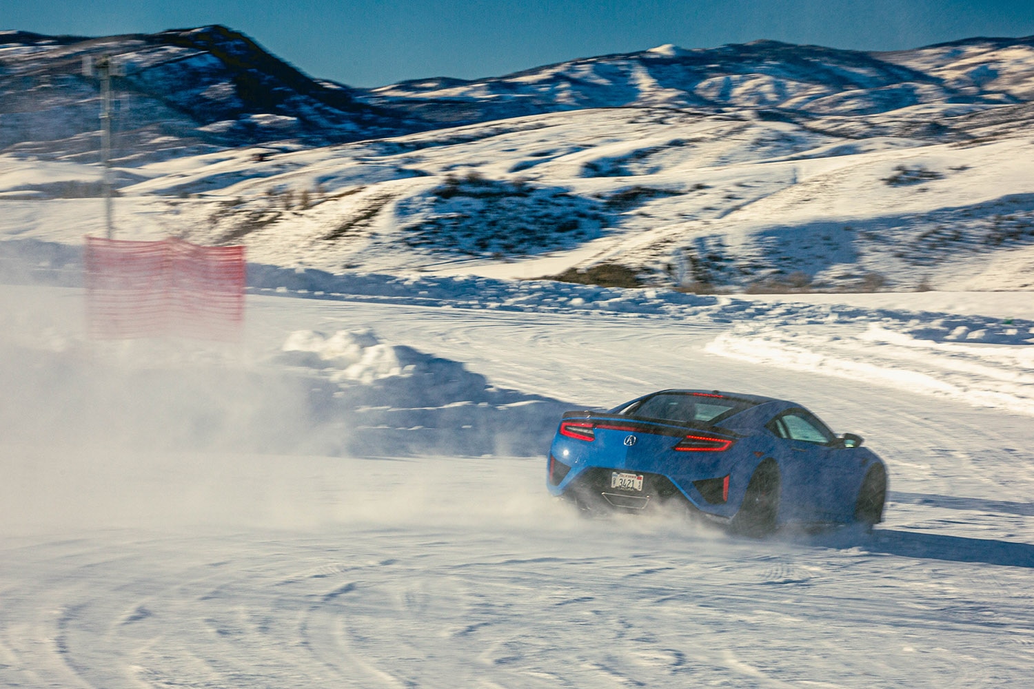Acura NSX Speeding Through Snow Rear