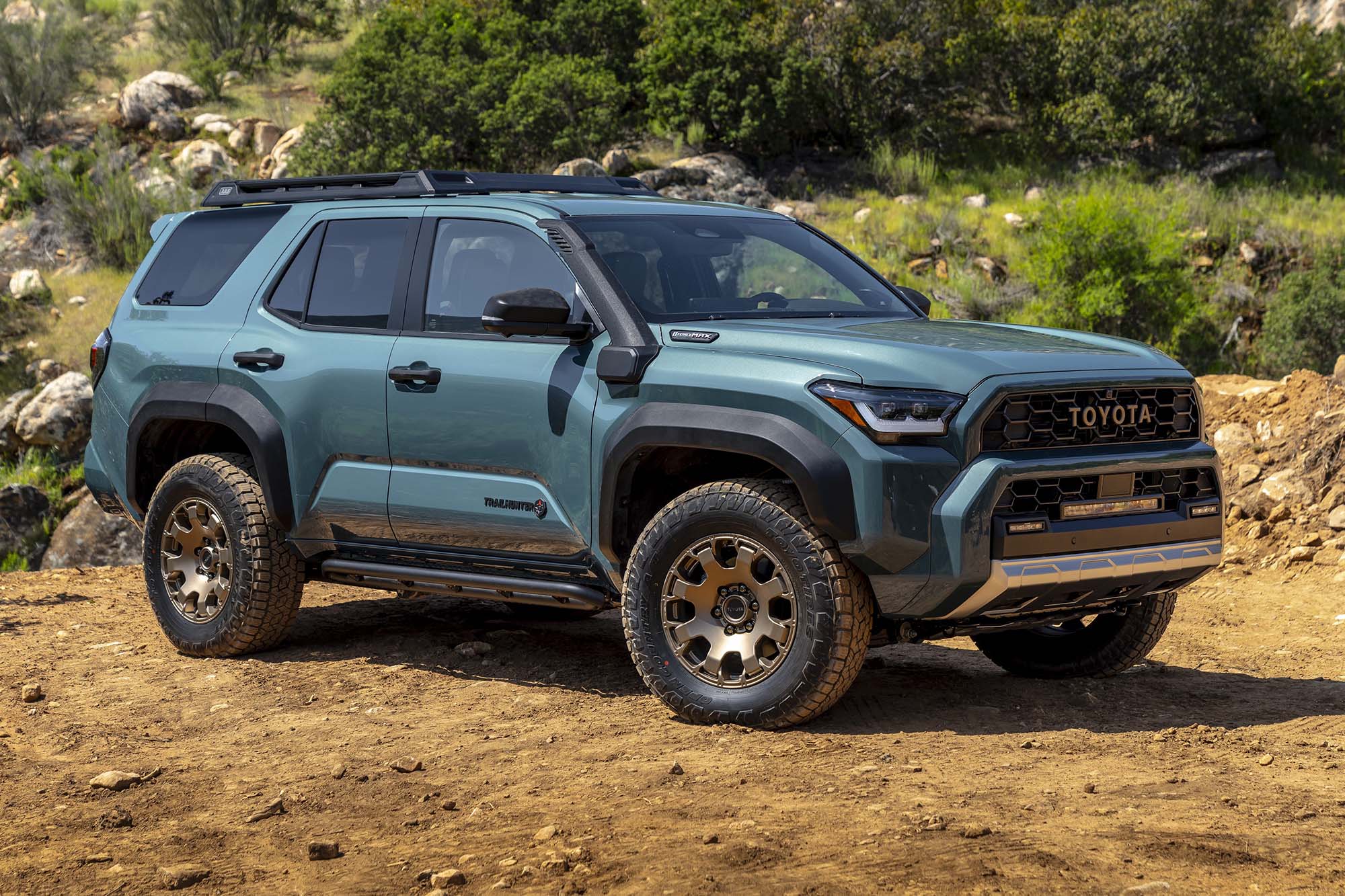 A right-front view of a blue 2024 Toyota 4Runner parked on dirt