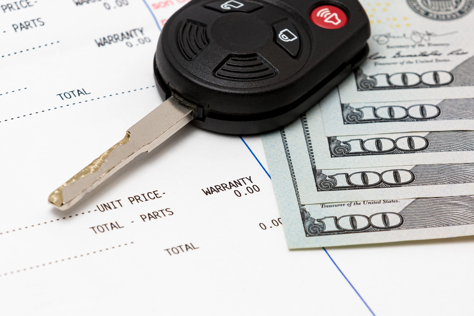 Car key, vehicle warranty repair bill and $100 bills