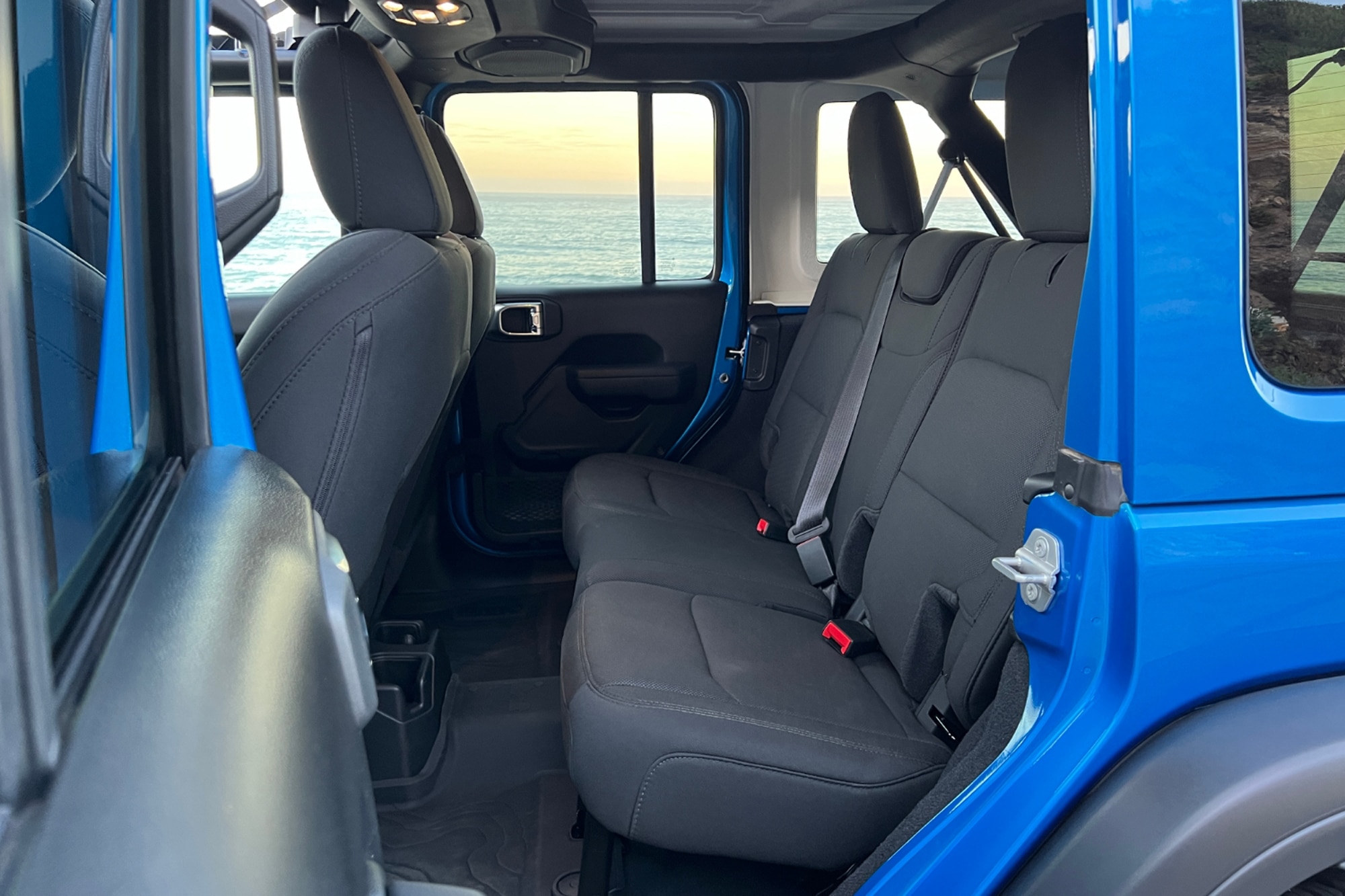 2022 Jeep Wrangler High Tide blue passenger back seat with view of ocean