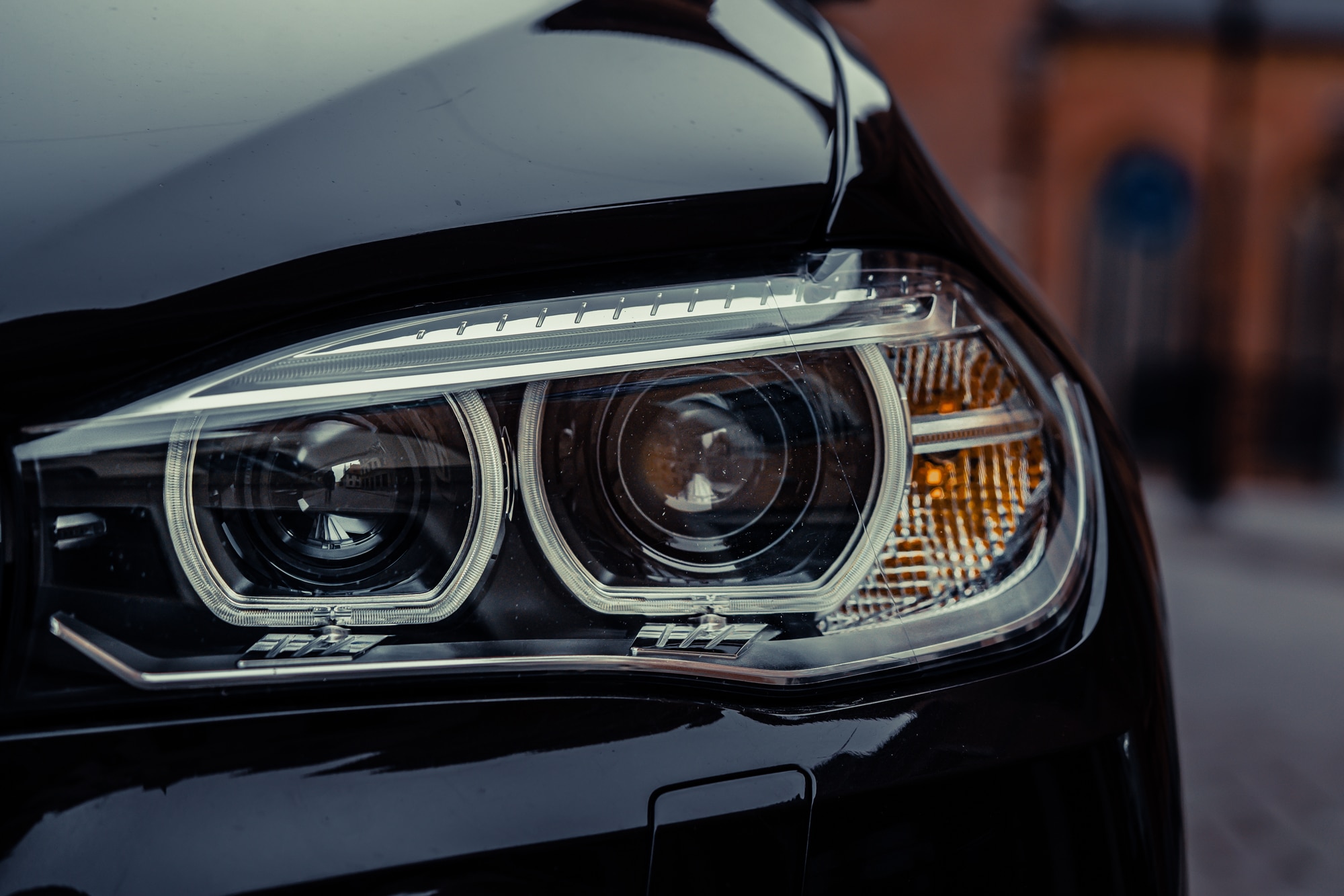 Black car headlights in daytime