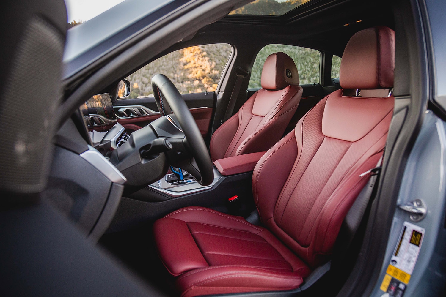 2022 BMW i4 M50 interior, Tacora Red Perforated SensaTec front seats