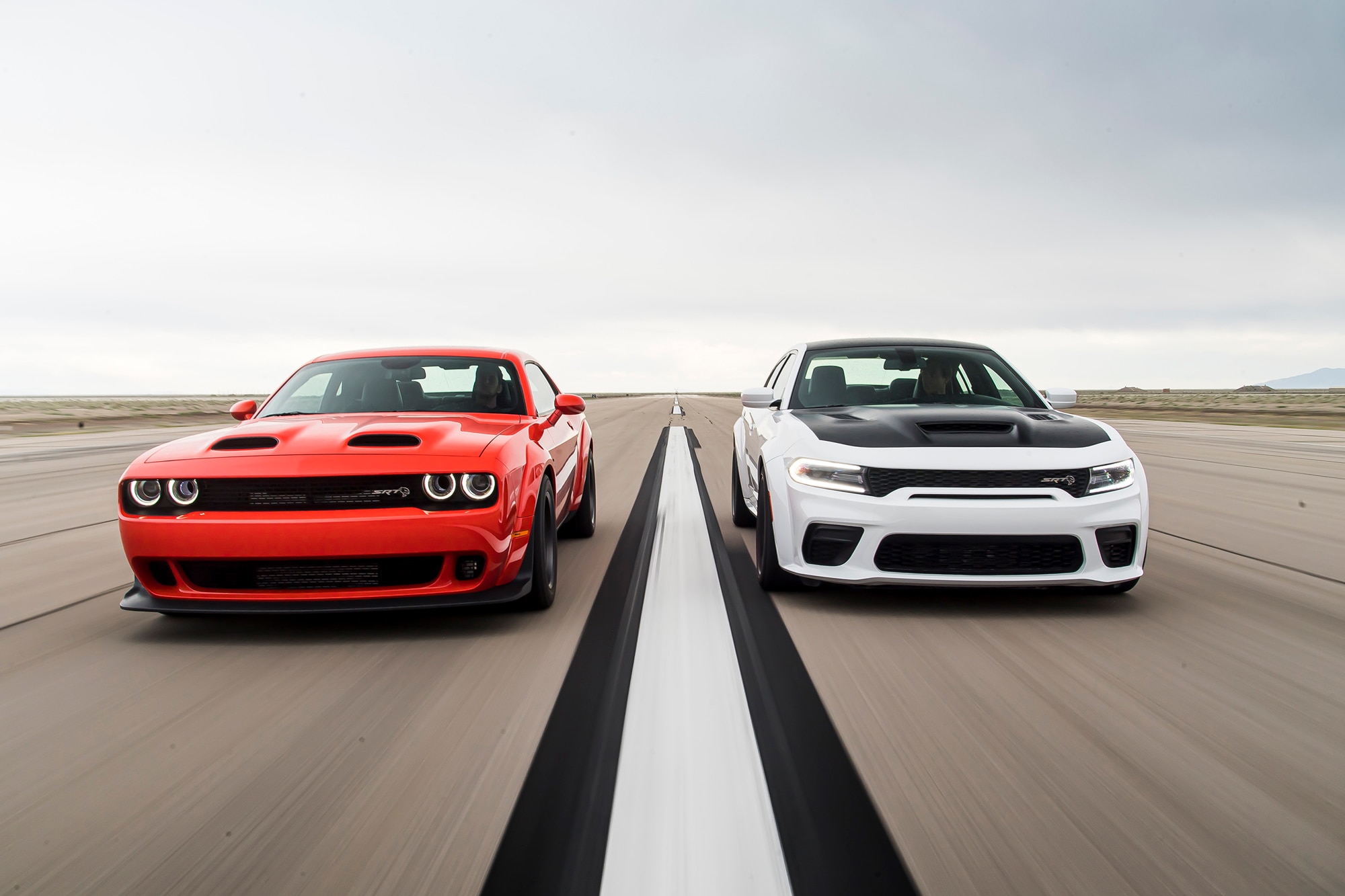 Red undefined White Dodge Challenger side by side