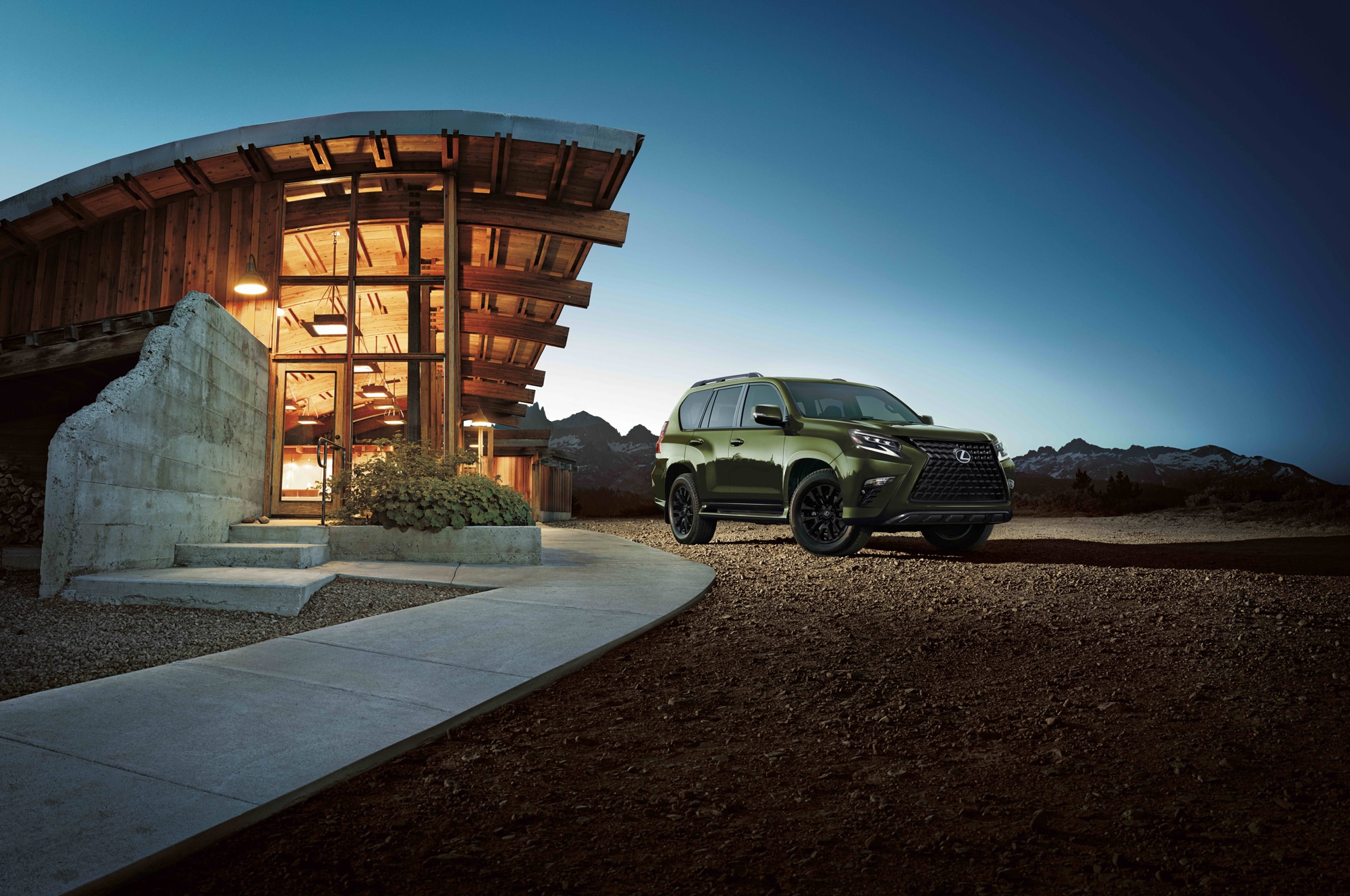 Green Lexus GX outside house with lighting in the mountains