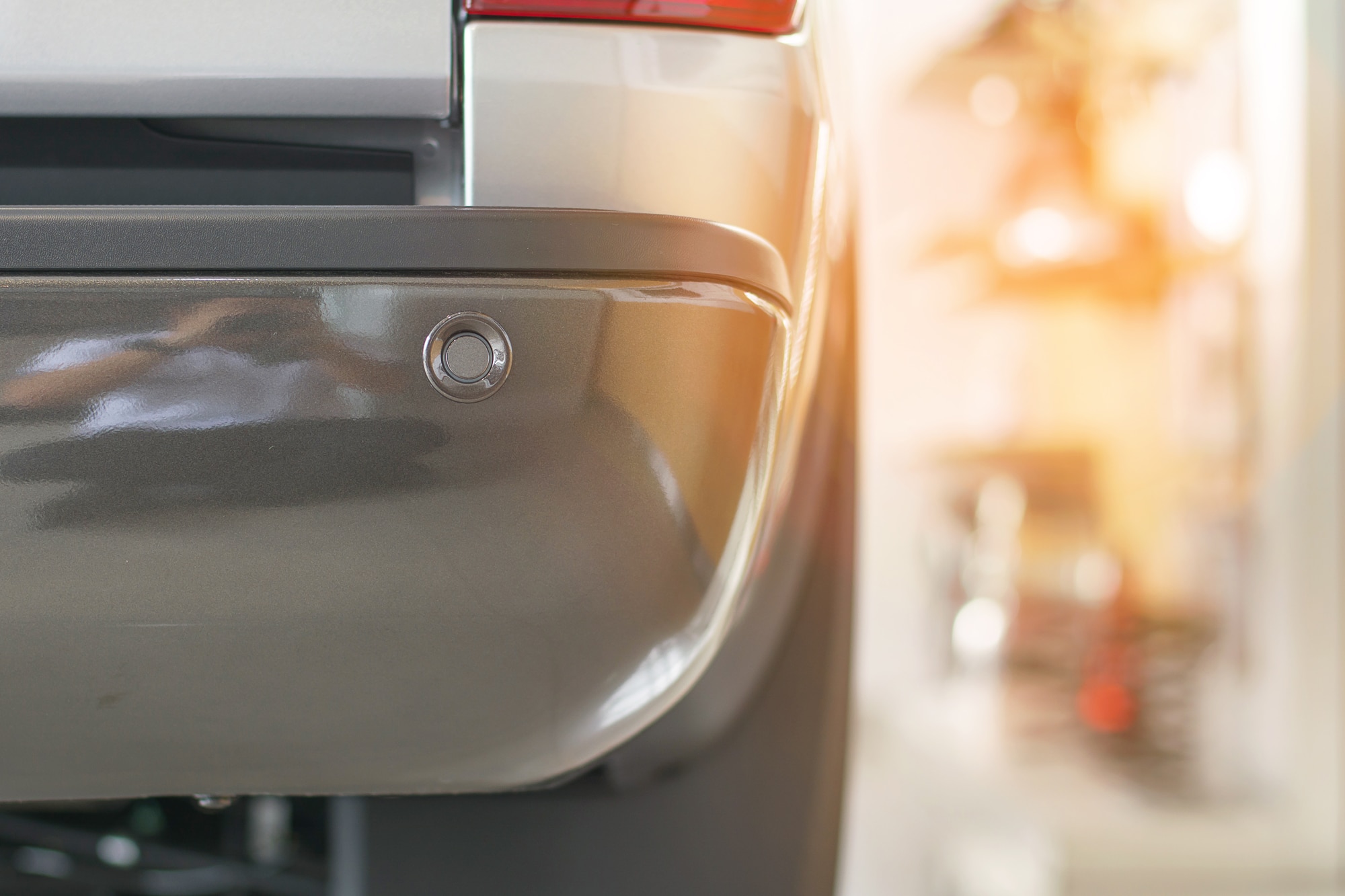 Selective focus on parking sensor on rear car bumper