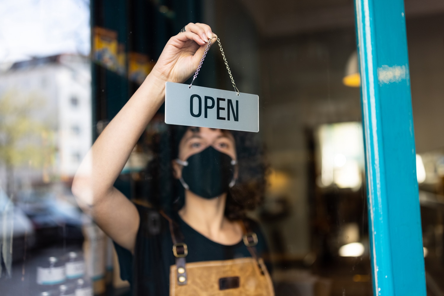 Woman placing open sign on business pandemic