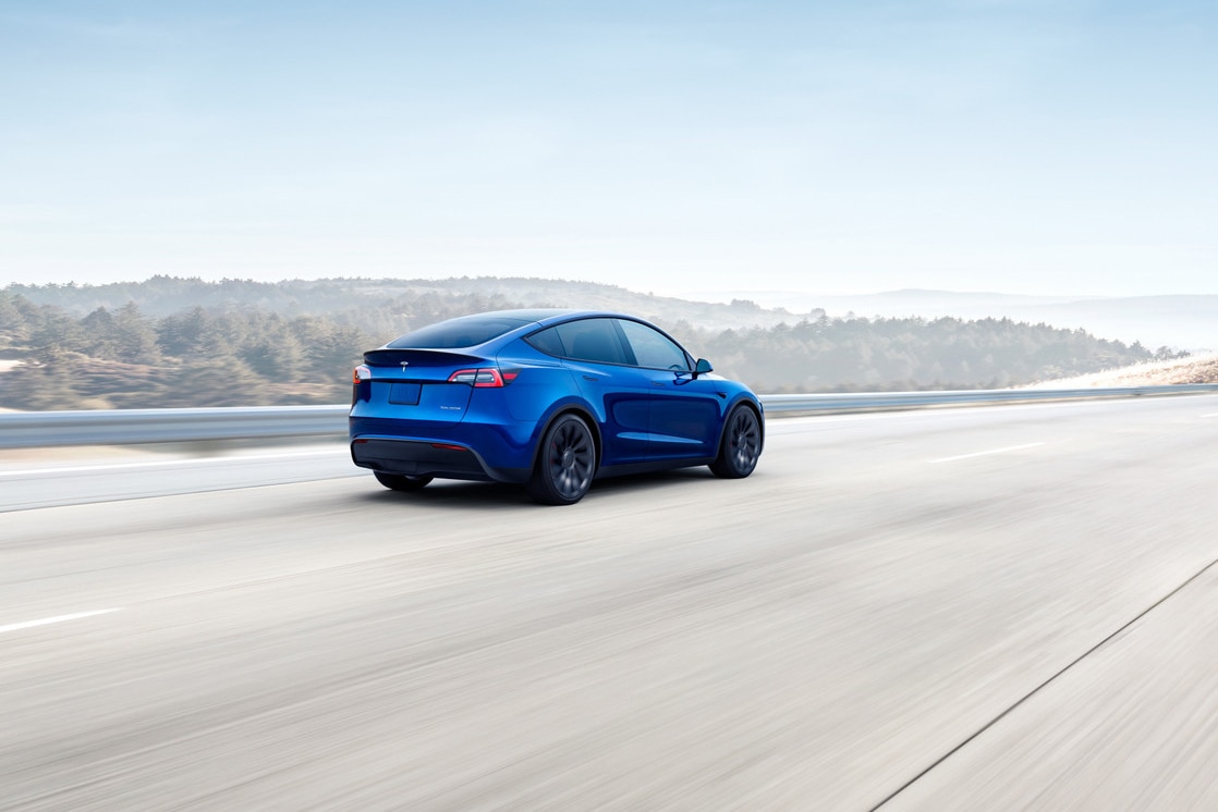 Tesla Model Y, blue, rear, driving