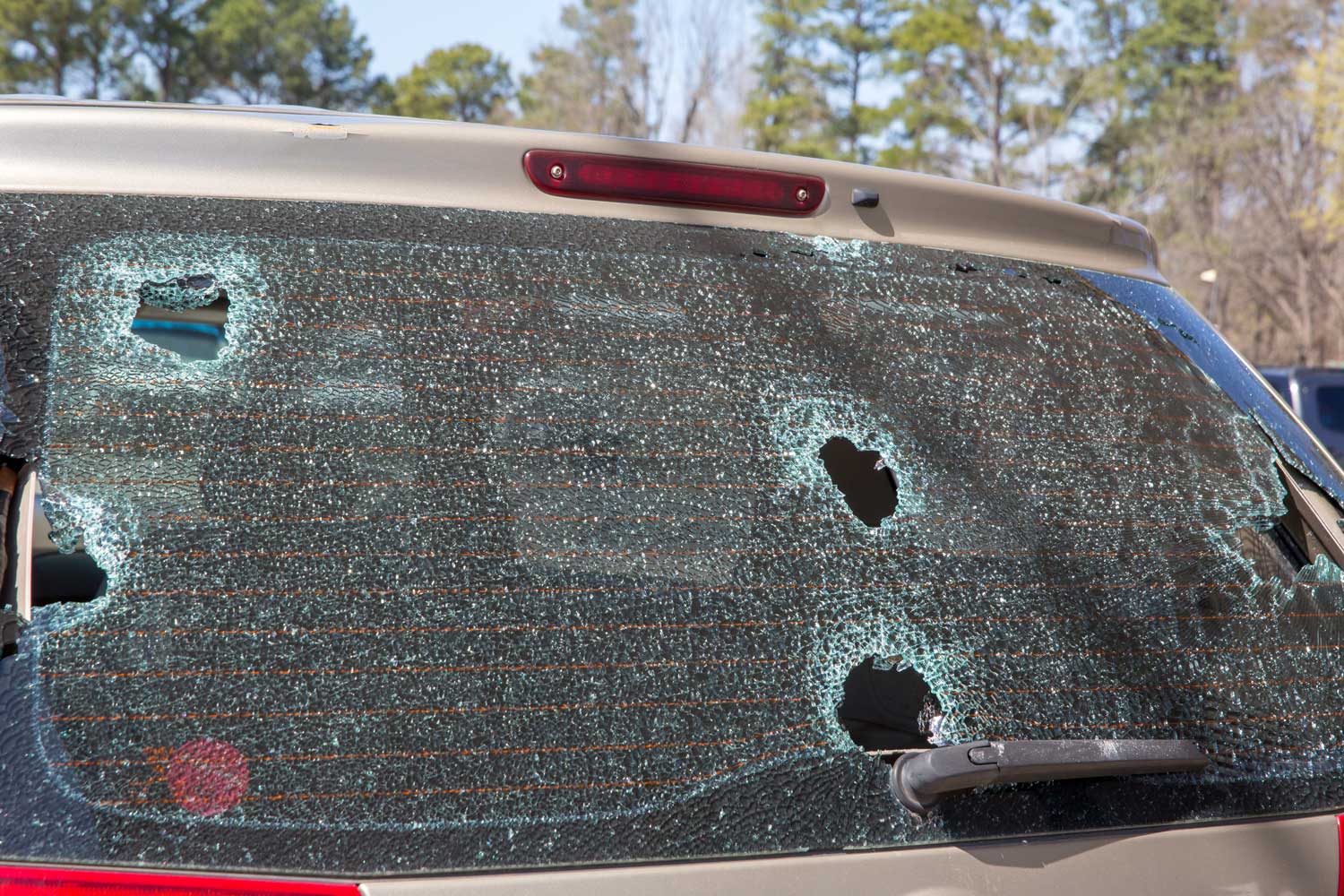 Hail damage on car van rear windshield