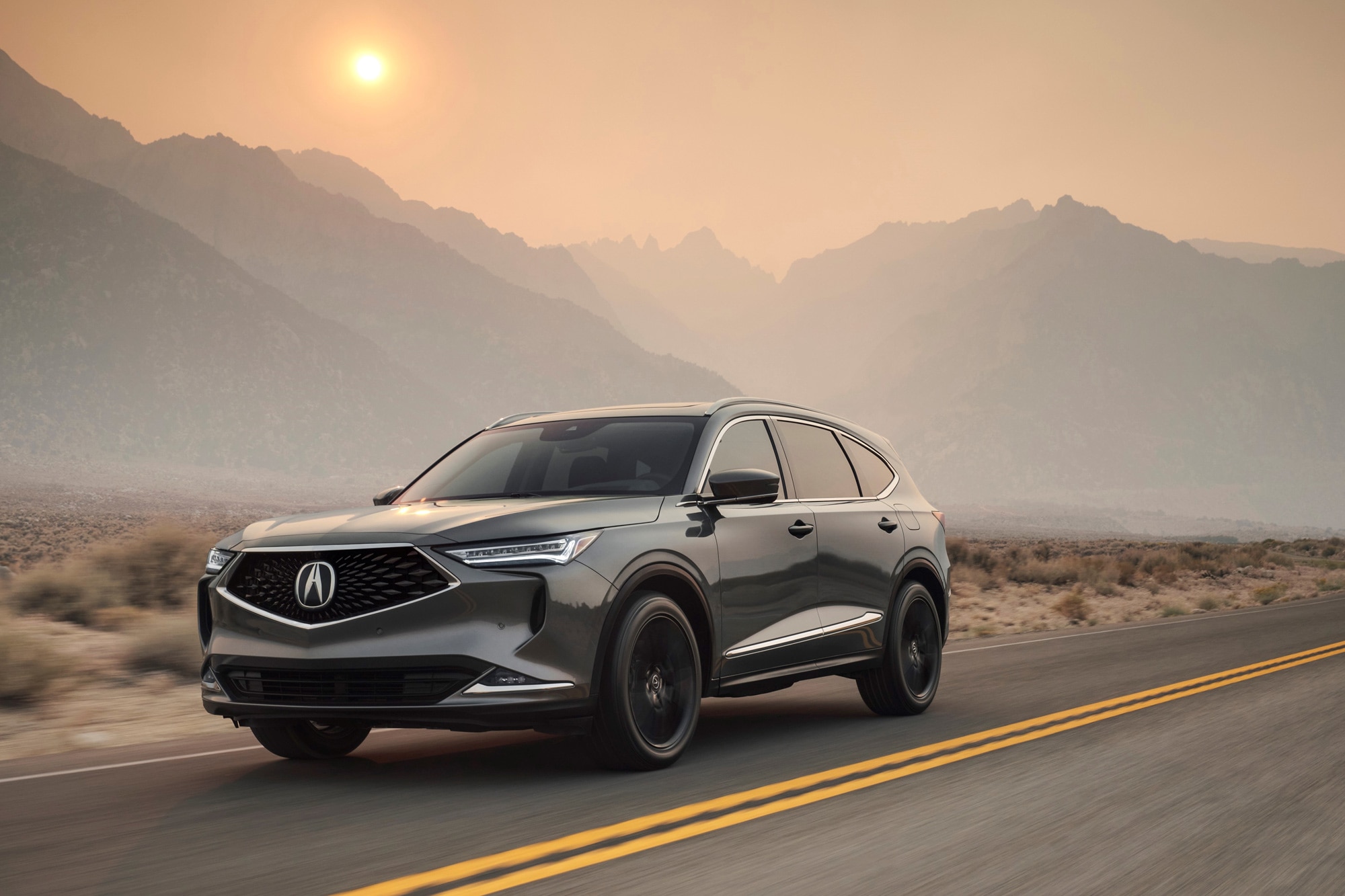 Gray 2023 Acura MDX on highway at sunset