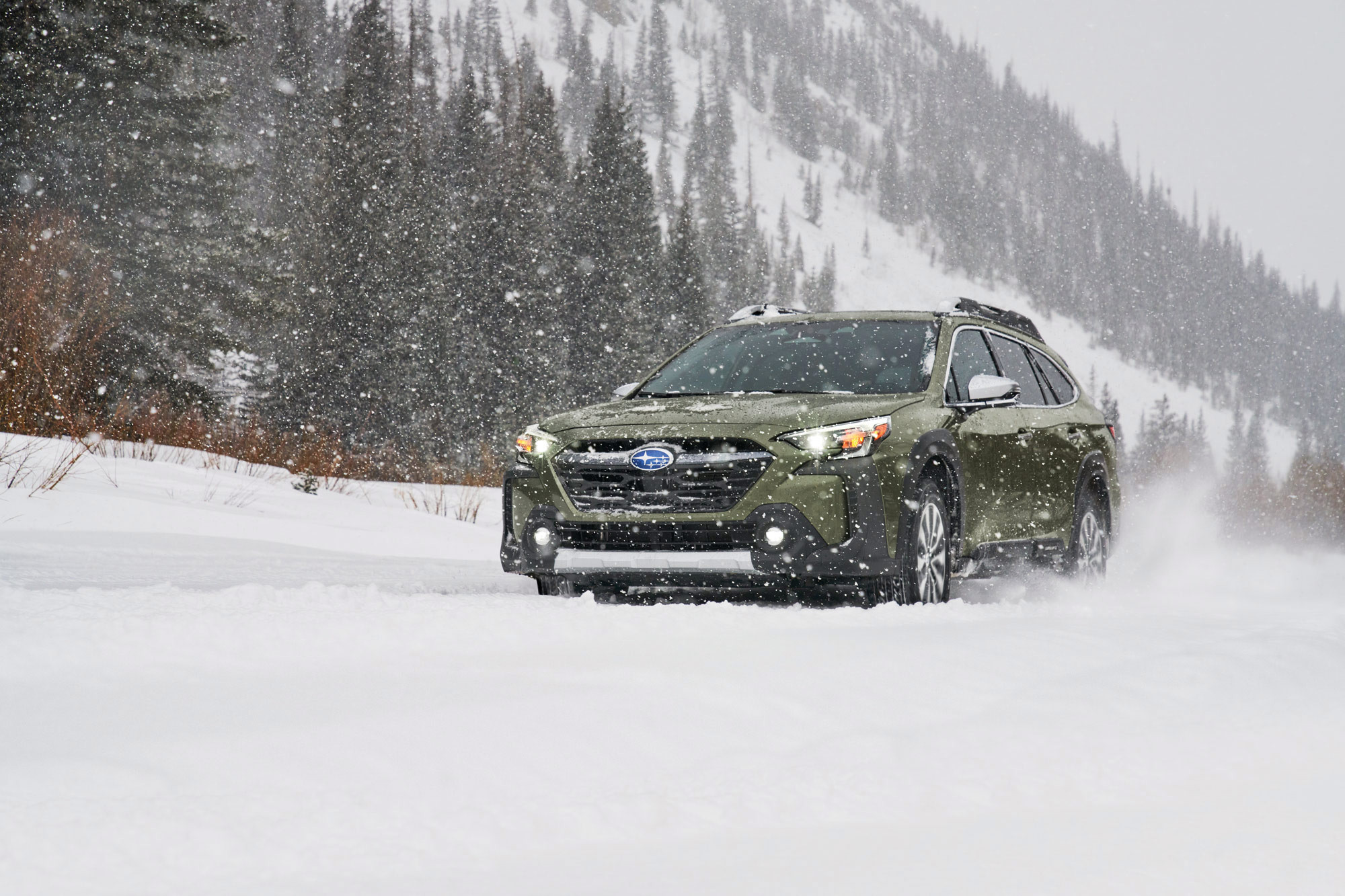 Green 2024 Subaru Outback in the snow