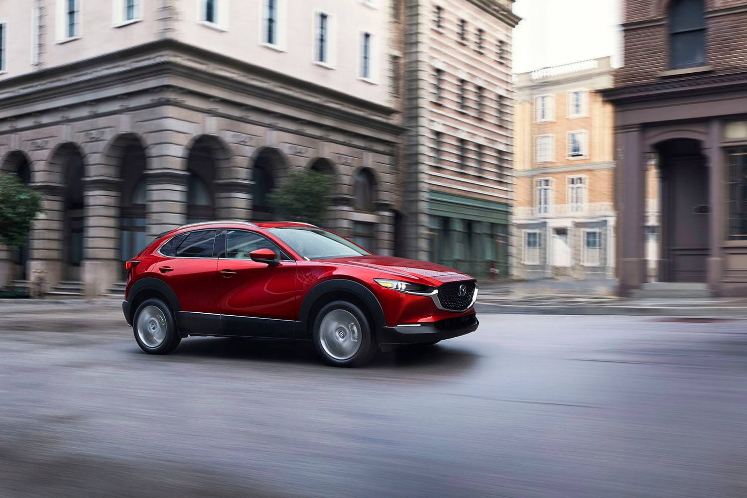 2023 Mazda CX-30 in red driving down a city street