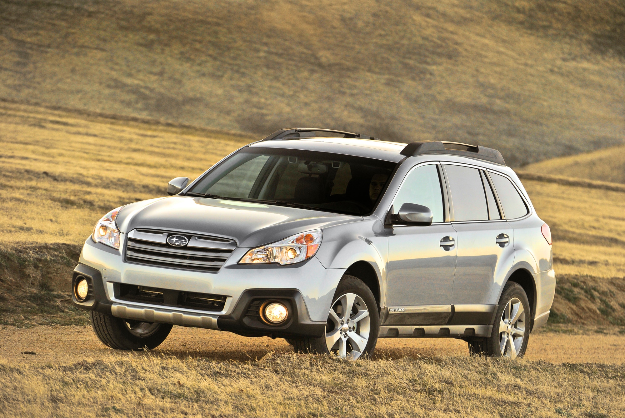 Gray 2012 Subaru Outback parked in mountain fields