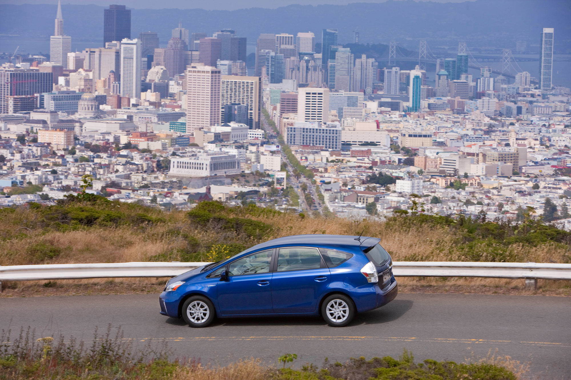 Blue 2013 Toyota Prius V with San Francisco in the background