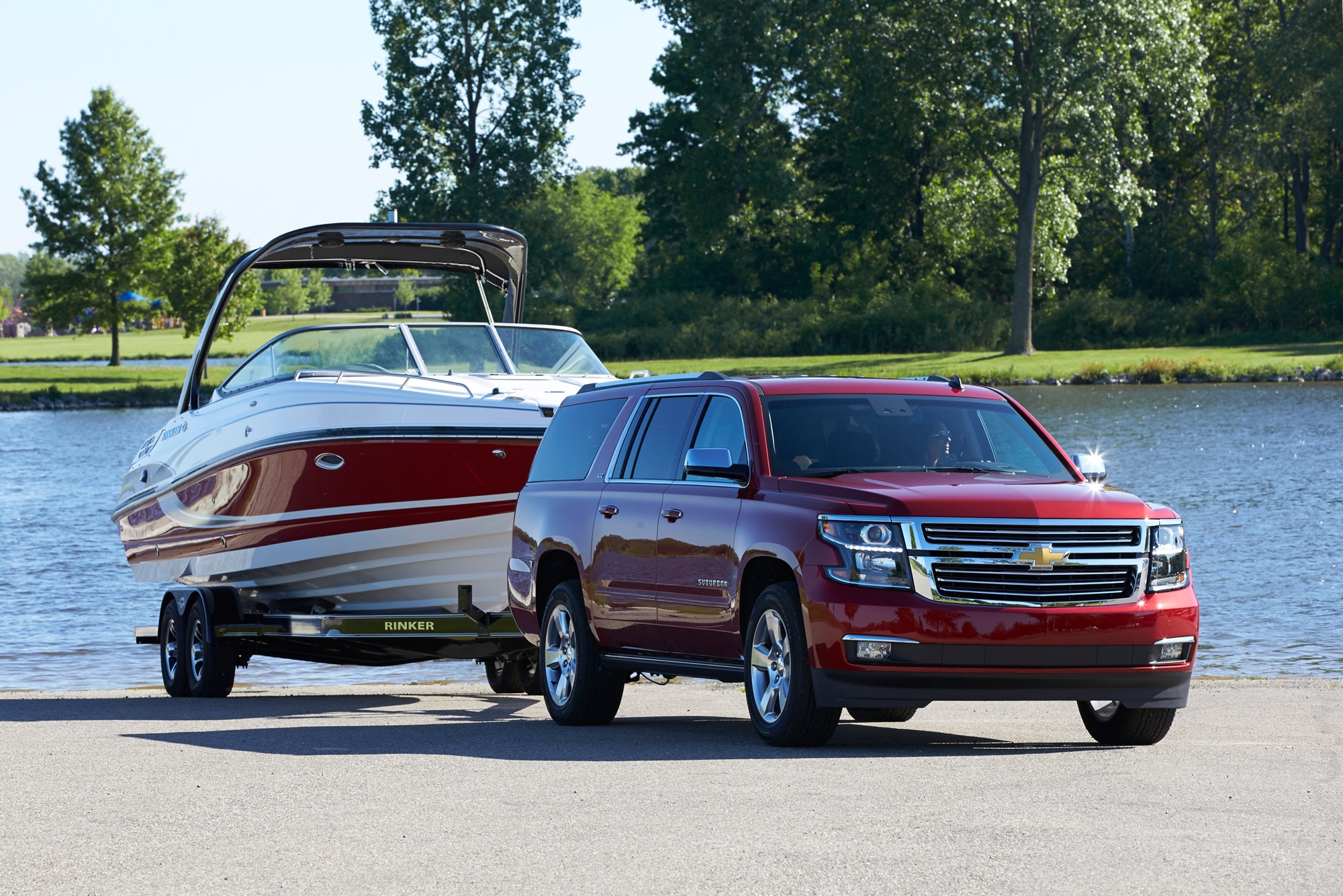 2015 Chevrolet Suburban LTZ pulling a Rinker boat by the lake