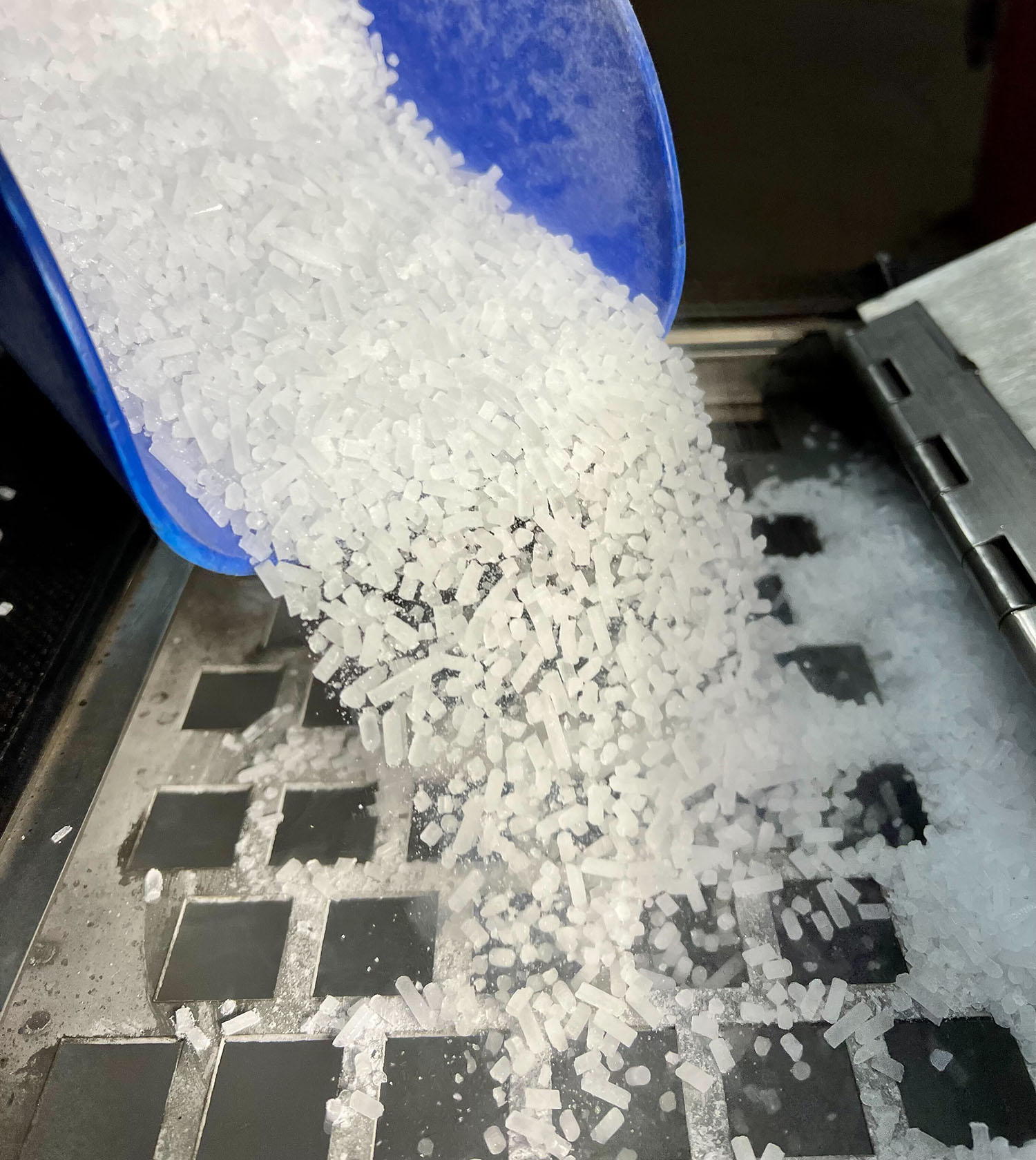 Dry ice pellets in scooper prior to dry ice blasting