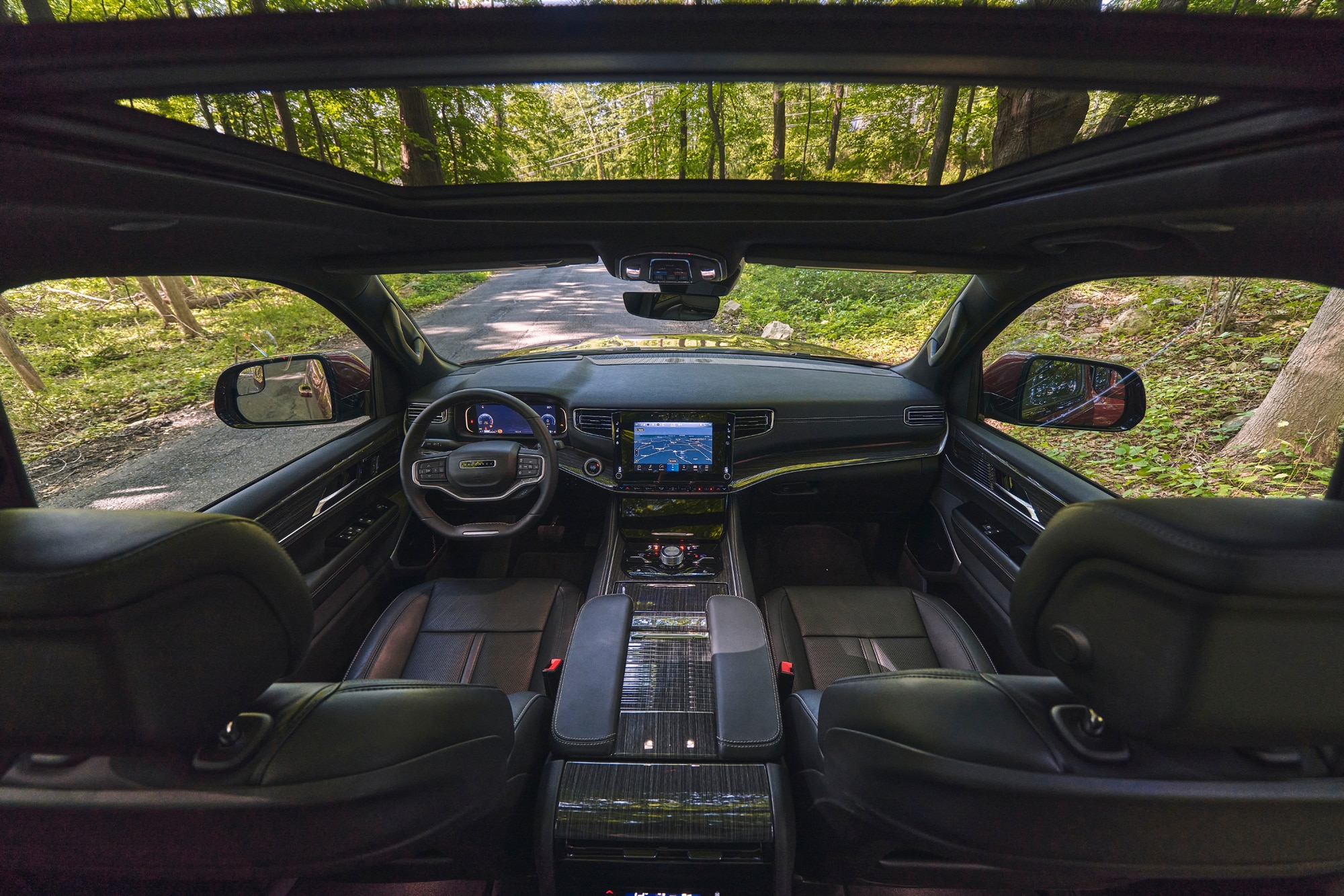 2023 Jeep Grand Wagoneer interior and dashboard with view of forest