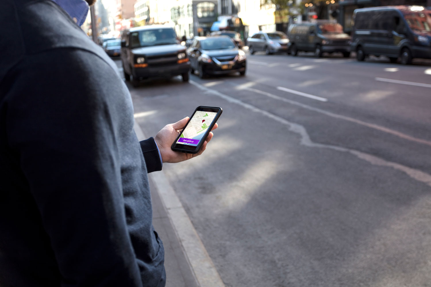 Man using phone app GPS car sharing