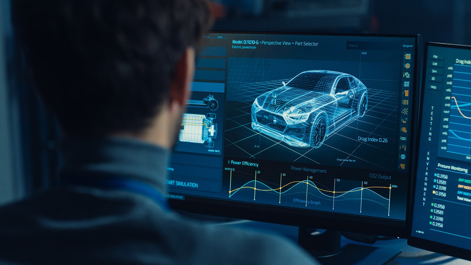 Man sitting at computer with car blueprint on screen