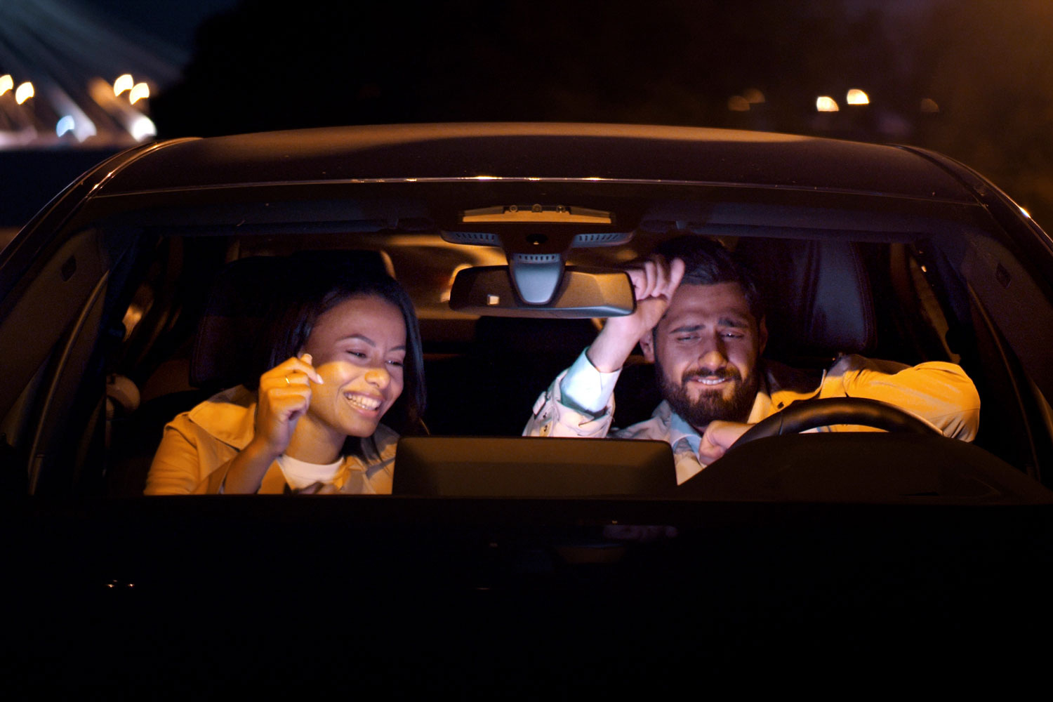 Man and woman listening to radio in car