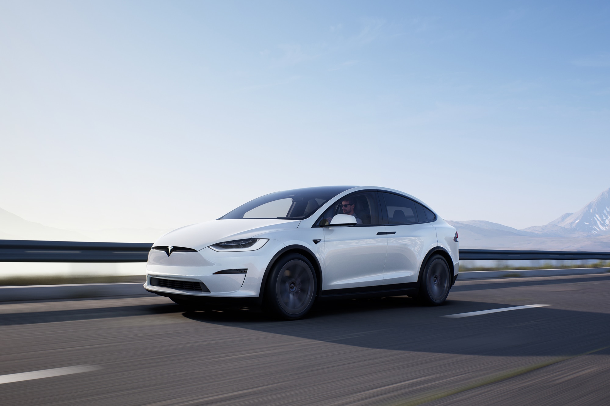 White 2022 Tesla Model X driving down highway
