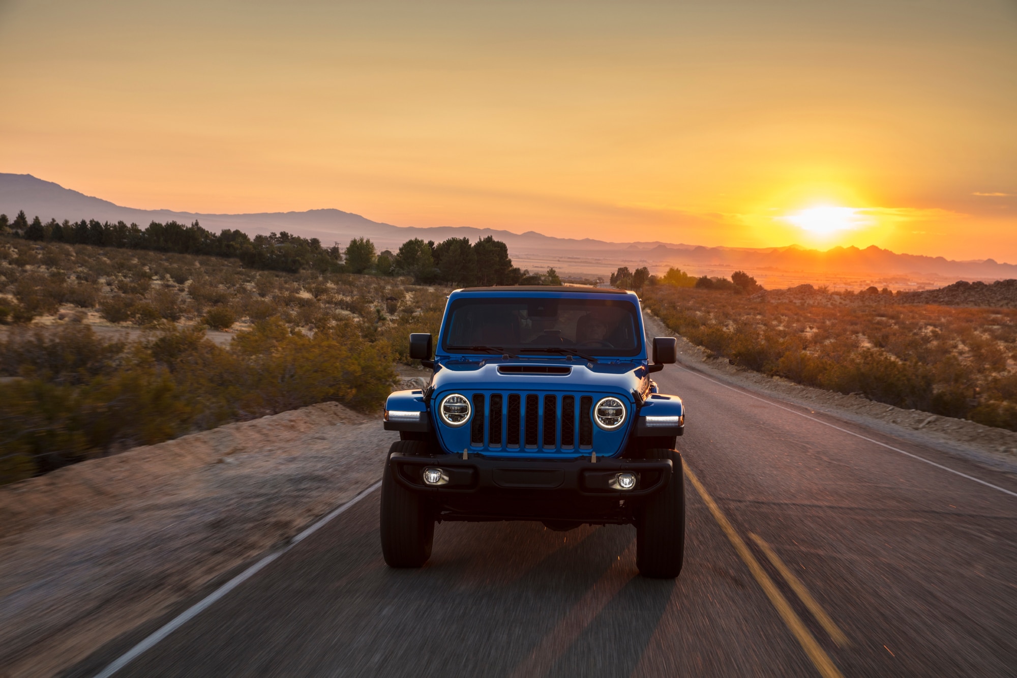 Blue 2023 Jeep Wrangler Rubicon 392 on desert highway