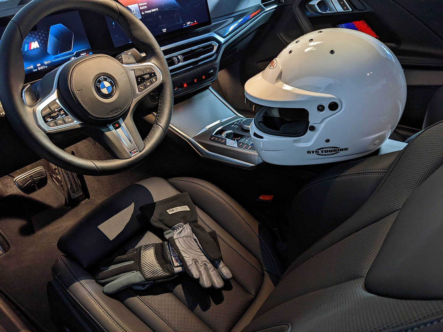 Helmet and driving gloves in cockpit of BMW