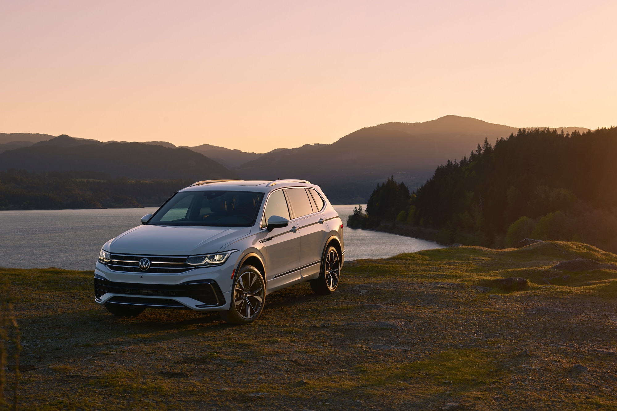 2022 Volkswagen Tiguan SEL R Line Oryx White parked on mountain side by lake