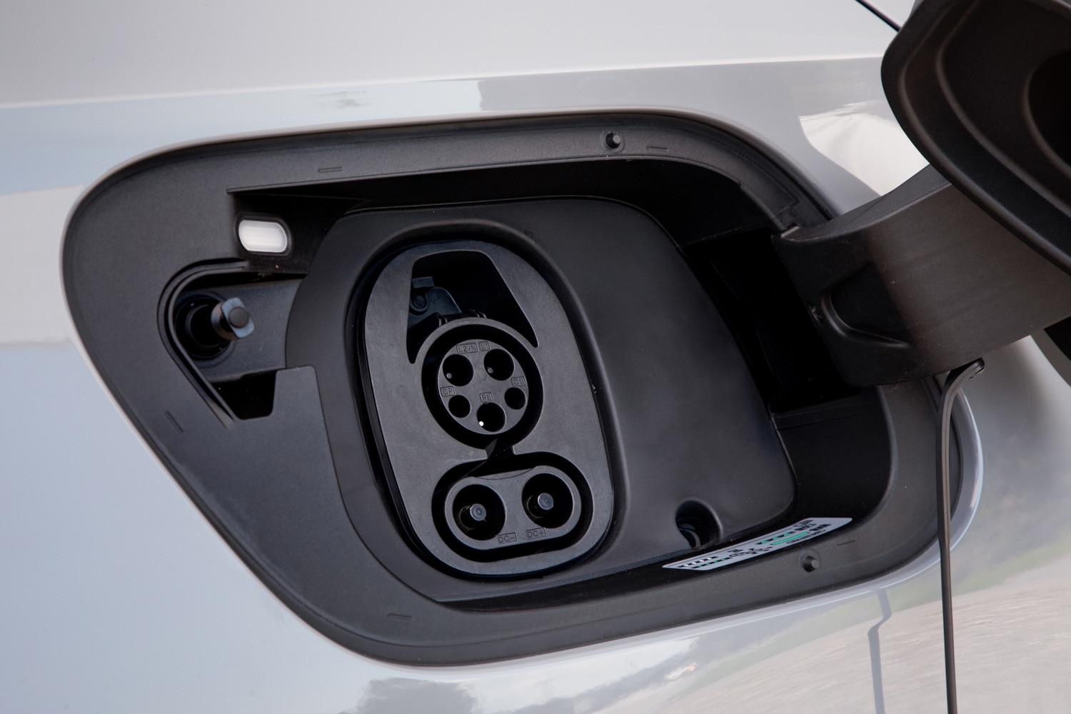 Closeup of an electric charging port on a vehicle.