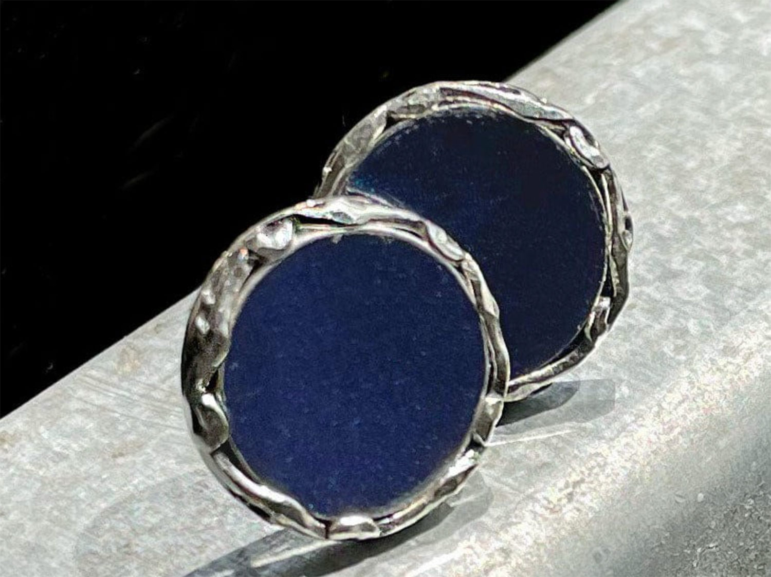 Round earrings with blue in the center and silver rims