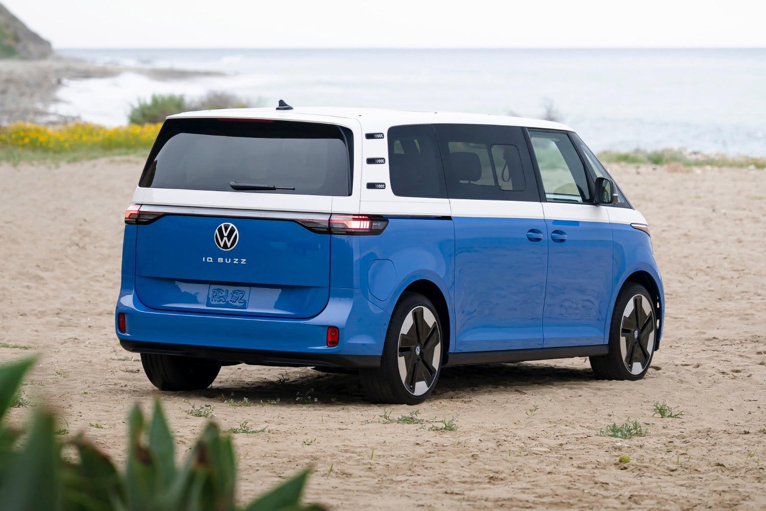 2025 Volkswagen ID. Buzz in blue and white on beachfront