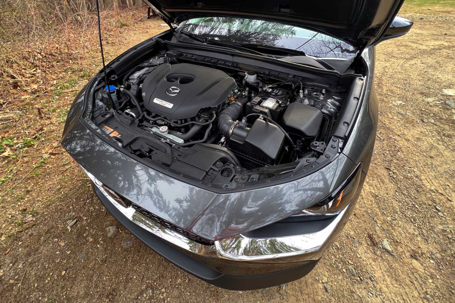 The engine compartment of a silver Mazda CX-30.