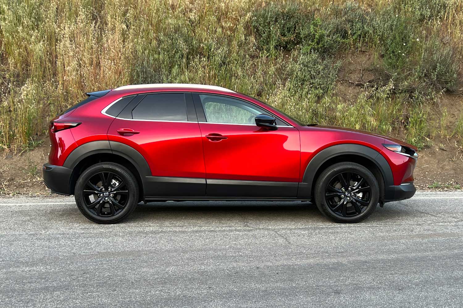 Side view of a red Mazda CX-30.