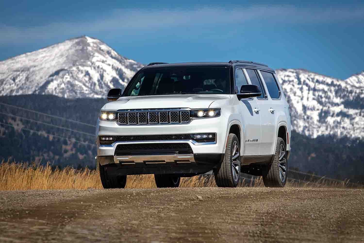  2023 Jeep Grand Wagoneer L in white with mountains behind it