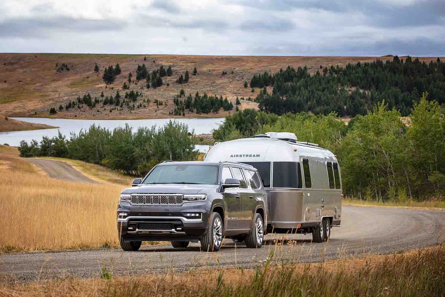  2023 Jeep Grand Wagoneer L in silver towing an Airstream