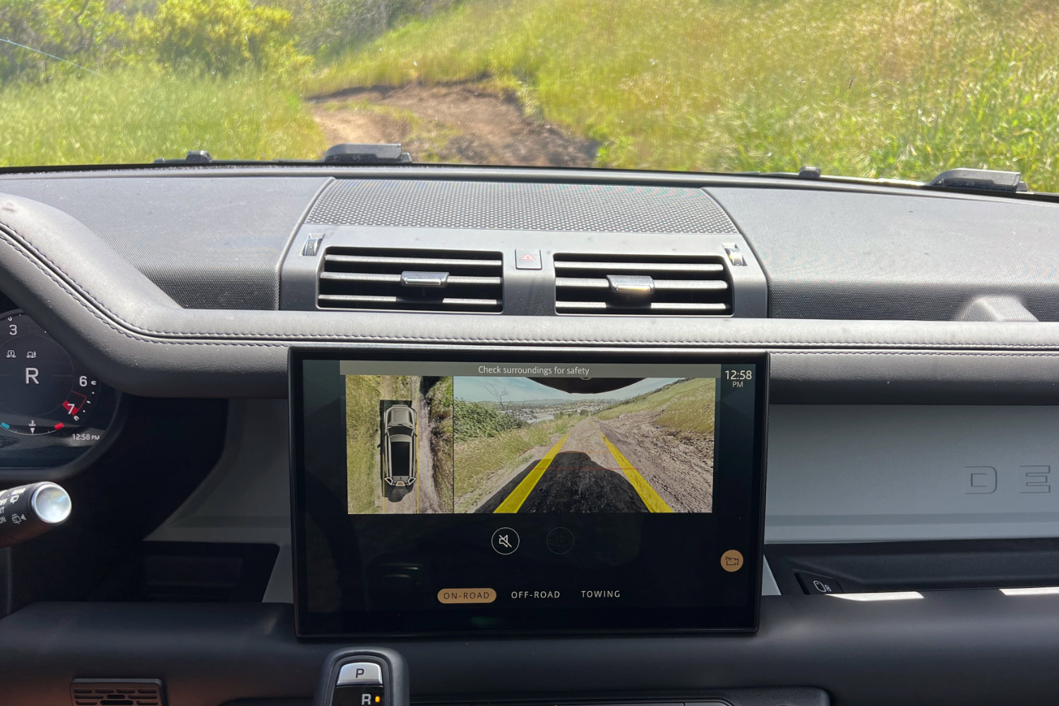 The center infotainment screen showing two views from the Defender 130's cameras