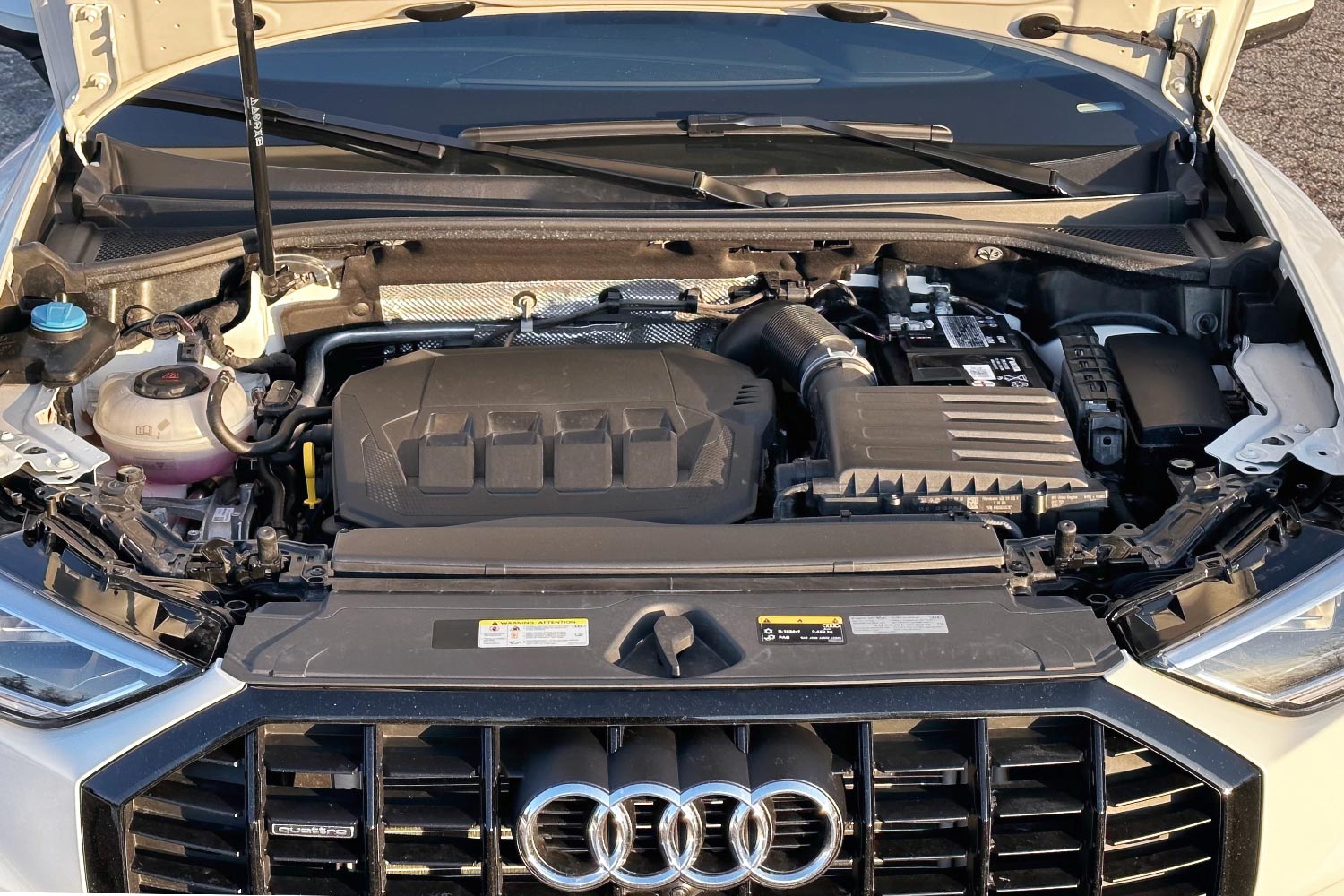 The engine compartment of an Audi Q3.