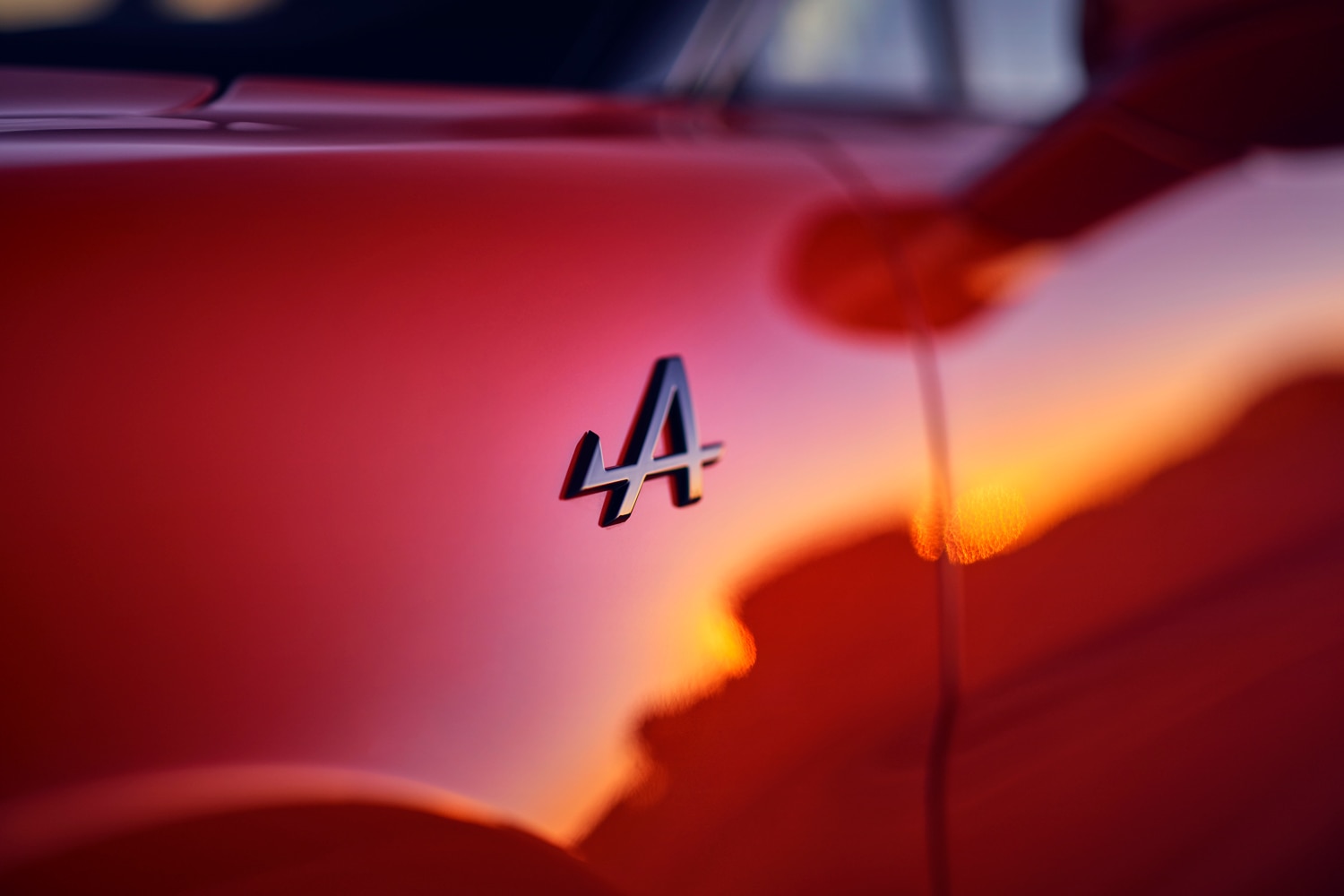 Closeup of the Alpine logo on the side of a red model