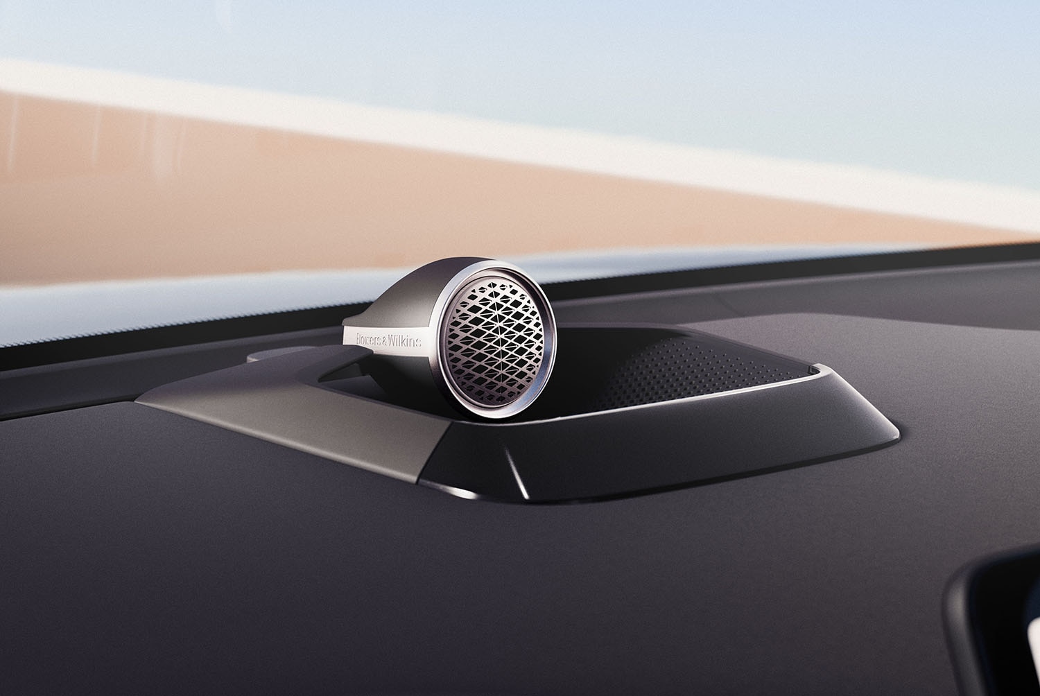 Bowers undefined Wilkins-branded circular stand-up speaker inside a Volvo
