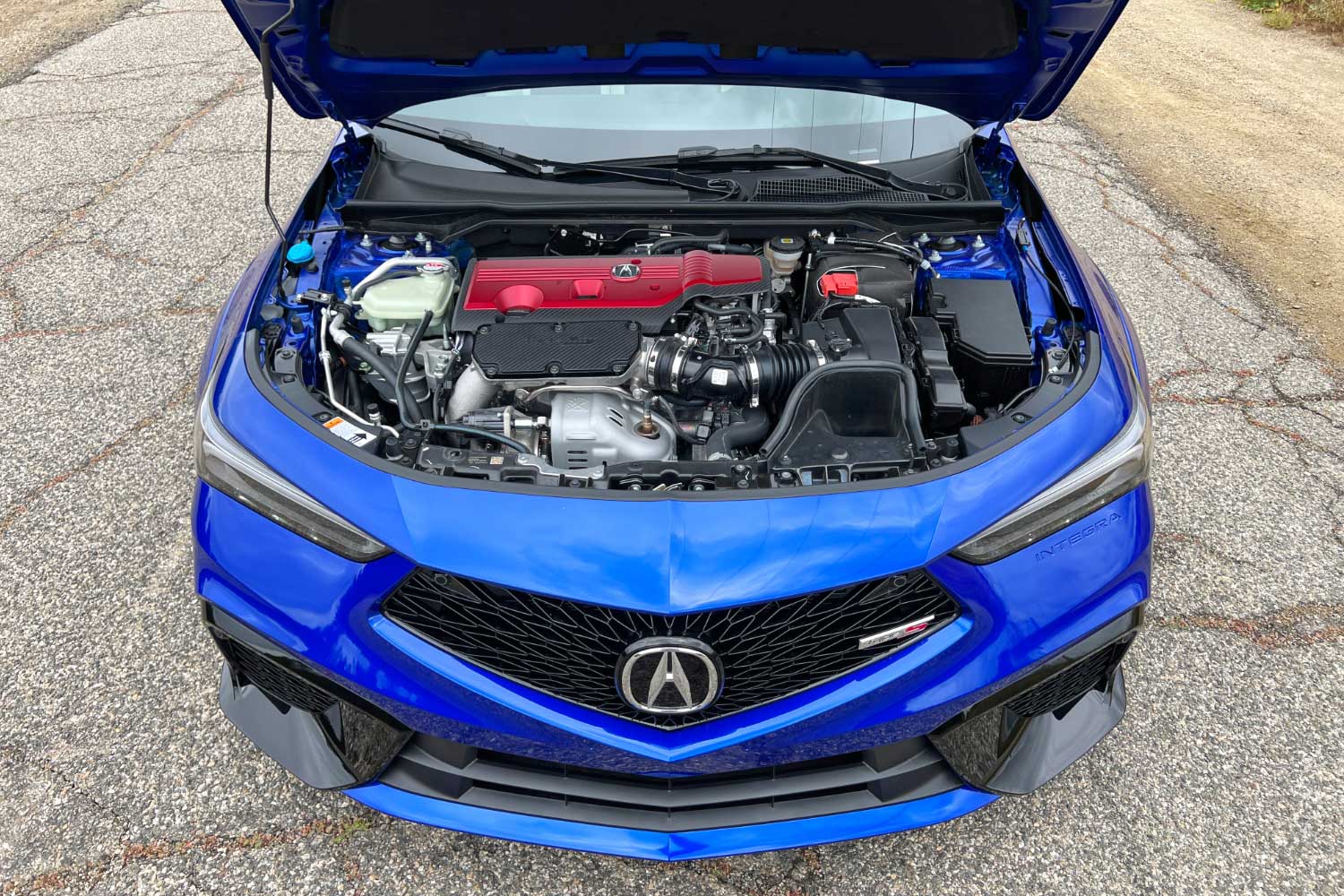 The engine compartment of a blue 2024 Acura Integra Type S.