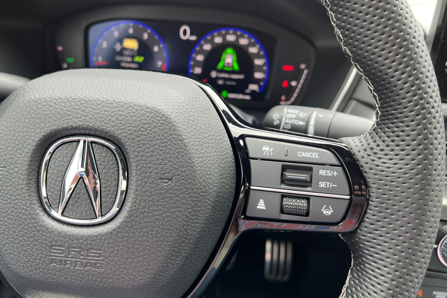 Closeup of a steering wheel and its controls in a 2024 Acura Integra Type S.