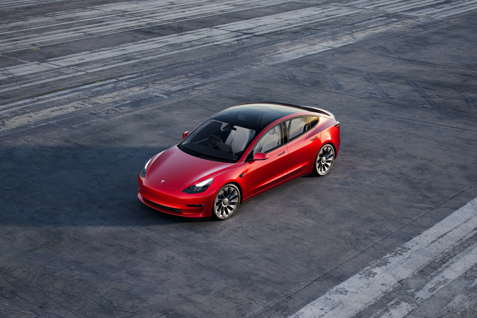 Red 2022 Tesla Model 3 in parking lot