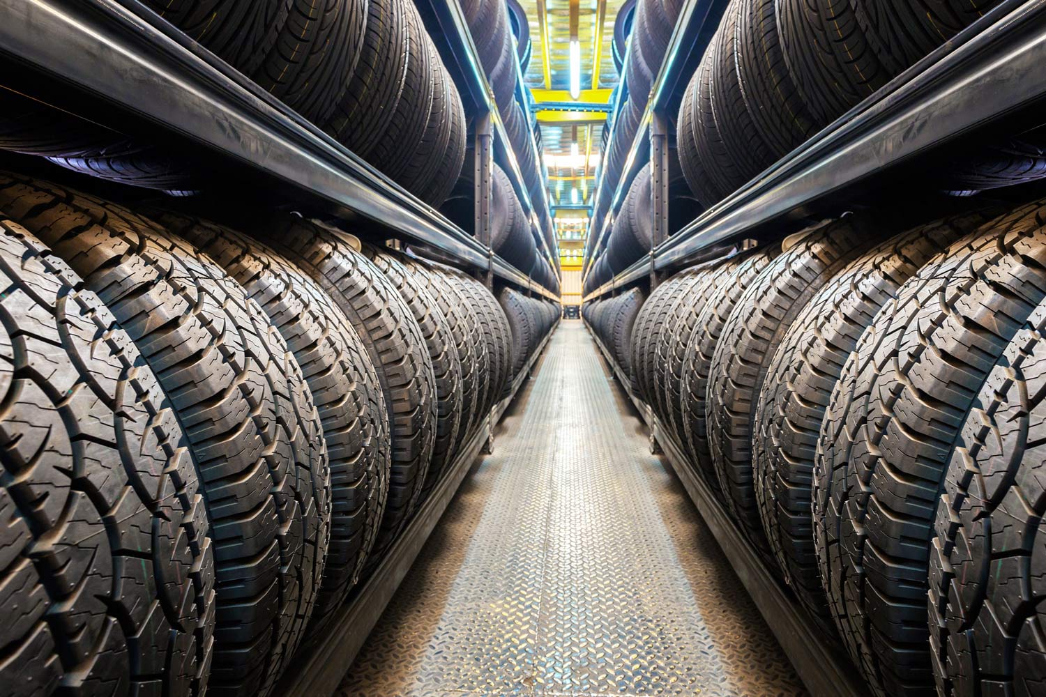 Aisle of tires stacked on shelves.