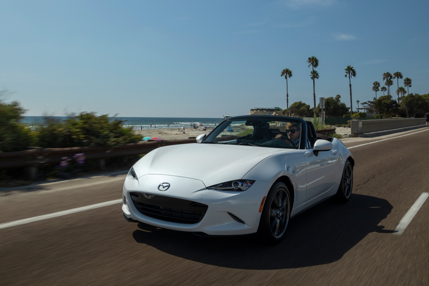 2023 Mazda MX-5 Miata driving by beach with top down