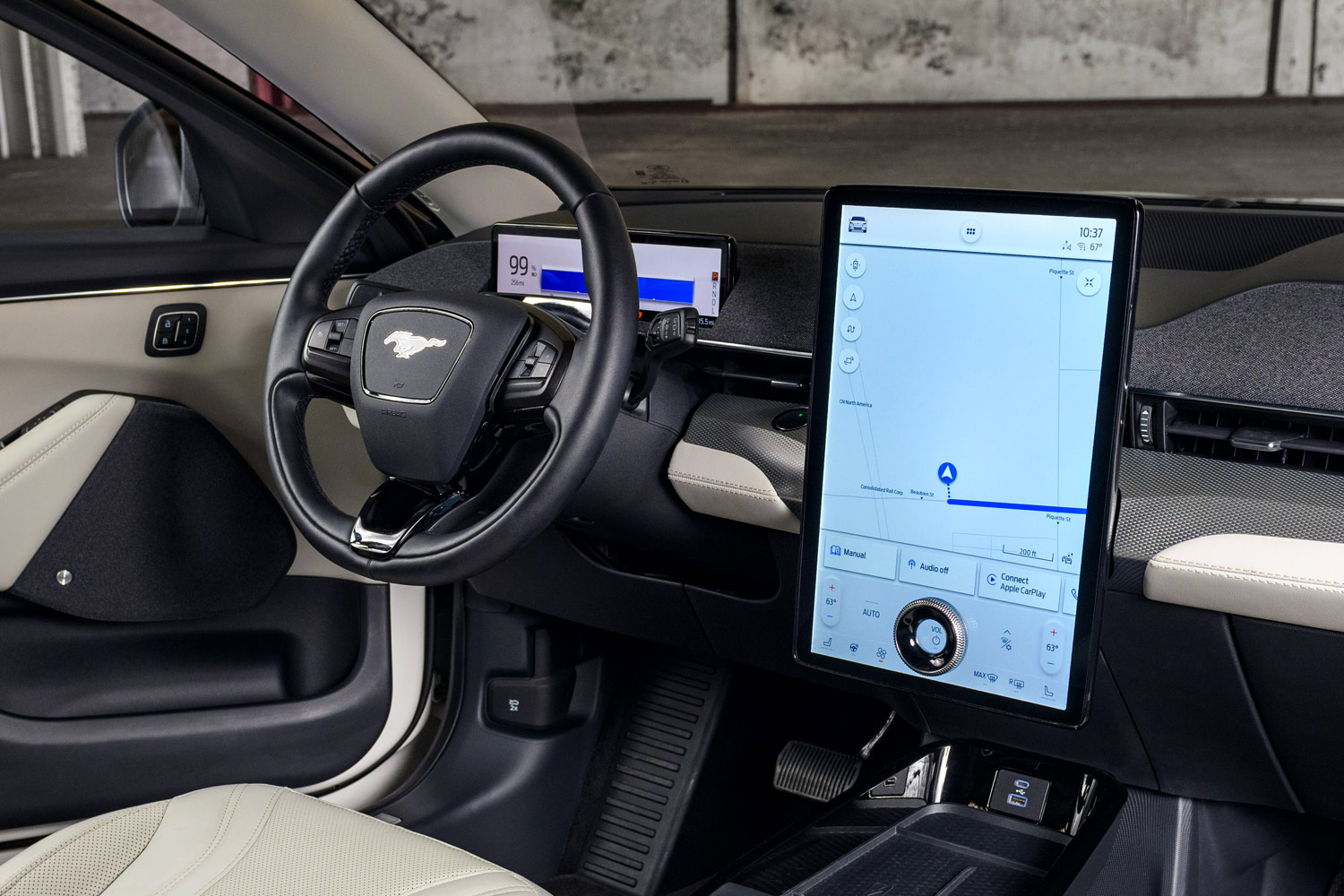 Interior of a Ford Mustang Mach-E showing a large infotainment touchscreen and steering wheel